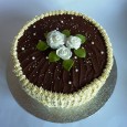 Honey sponge cake with fresh whipped cream. Sugar paste roses, chocolate and fresh whipped cream decorations.