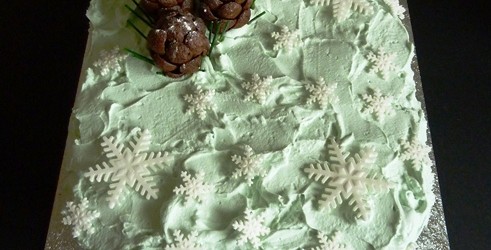 Chocolate sponge with mascarpone cheese, caramel and roasted walnuts filling. Fresh whipped cream, ready to roll icing decorations.